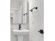 Bathroom with pedestal sink, modern black faucet, and large mirror with black trim at 4 Wappoo Trace Ln, Summerville, SC 29486