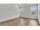 Spacious bedroom showcasing two large windows for ample natural light and wood-style flooring at 4 Wappoo Trace Ln, Summerville, SC 29486