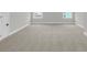 Spacious bonus room with neutral carpet, white trim, and two windows for lots of natural light at 4 Wappoo Trace Ln, Summerville, SC 29486