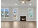 Bright living room with wood-look floors and a modern fireplace at 4 Wappoo Trace Ln, Summerville, SC 29486
