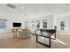 Open-concept living room with a ping pong table, large TV, and comfortable seating area at 11 Wappoo Trace Ln, Summerville, SC 29486