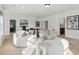 Bright living room featuring modern white sofas, stylish decor, and ample natural light at 11 Wappoo Trace Ln, Summerville, SC 29486