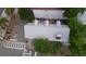 Aerial view of roof with tin/aluminum-looking material with surrounding trees and people working near a white building at 59 Ashe St, Charleston, SC 29403