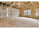 Spacious unfinished room showcasing framing and window, ready for customization and personalization at 9 Wappoo Trace Ln, Summerville, SC 29486