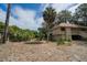 View of the side and back of the house showcasing tropical landscaping and privacy at 818 Club Cottage Court, Edisto Beach, SC 29438