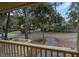 Balcony view overlooking a winding road, green space, a pond and attractive neighboring homes at 818 Club Cottage Court, Edisto Beach, SC 29438