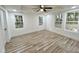 Bright bedroom with wood-look floors, ceiling fan, and multiple windows at 861 Savage Rd, Charleston, SC 29414