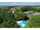 Aerial view of the community pool, tennis courts, and surrounding homes nestled amongst lush greenery at 1712 Live Oak Park, Seabrook Island, SC 29455