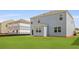 A light blue home with a large, green backyard and neighboring homes still under construction at 285 Blue Haw Dr, Moncks Corner, SC 29461