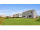 A side angle of a light blue house with a spacious green backyard and neighboring homes at 285 Blue Haw Dr, Moncks Corner, SC 29461