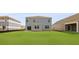 A large, green backyard with a light blue house with white trim and other homes nearby at 285 Blue Haw Dr, Moncks Corner, SC 29461