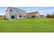 A spacious backyard features lush green grass and a light blue house with white trim at 285 Blue Haw Dr, Moncks Corner, SC 29461