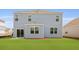 A light blue house with white trim overlooks a spacious green backyard with a patio at 285 Blue Haw Dr, Moncks Corner, SC 29461
