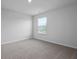 A bright bedroom with neutral carpet and a window with blinds for natural light at 285 Blue Haw Dr, Moncks Corner, SC 29461