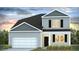 Two-story home with gray siding, black shutters, and a two-car garage at 285 Blue Haw Dr, Moncks Corner, SC 29461