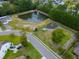 Aerial view of pond, playground, and walking trail in neighborhood at 575 Rosings Dr, Summerville, SC 29486