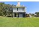 Exterior showing the beautiful yard and stilt construction at 7848 Pelican Bay Dr, Awendaw, SC 29429