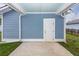 Exterior view of covered parking and back door with green grass at 208 Sweetspire Ln, Summerville, SC 29483