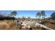 Relaxing community fire pit area with benches overlooking a pond at 803 Lachicotte Creek Dr, Charleston, SC 29492