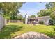 Large backyard with grassy lawn, screened porch, and wooden fence at 1466 Glencoe St, Mount Pleasant, SC 29464
