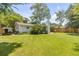 Spacious backyard features a grassy lawn and a white brick house at 1466 Glencoe St, Mount Pleasant, SC 29464