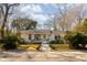 Charming white brick ranch home with landscaped yard and walkway at 1466 Glencoe St, Mount Pleasant, SC 29464