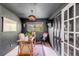 Dark-walled home office with built-in shelving and French doors at 1466 Glencoe St, Mount Pleasant, SC 29464