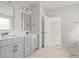Bathroom with double sink vanity, gray cabinets, stylish mirror, and doorway to bedroom at 506 Fiskdale Cir, Summerville, SC 29486