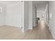 Bright hallway with white walls, modern wood-look flooring, and paneled accent wall in adjacent room at 506 Fiskdale Cir, Summerville, SC 29486