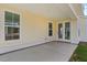 Covered patio features a concrete slab, access to the house through a glass door, and a view of the backyard at 506 Fiskdale Cir, Summerville, SC 29486