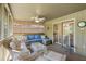 Inviting sunroom with comfortable wicker furniture, blue cushions, and a ceiling fan for relaxed living at 1101 Summerwind Ln, Seabrook Island, SC 29455