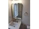 Modern bathroom with gold fixtures, mirror, and white countertop at 22 Iron Forge Aly, Charleston, SC 29403
