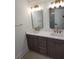 Elegant bathroom featuring double vanity with gold fixtures and mirrors at 22 Iron Forge Aly, Charleston, SC 29403