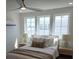 Bright bedroom features neutral tones, three windows, and a modern ceiling fan at 22 Iron Forge Aly, Charleston, SC 29403