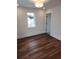 Bright, empty bedroom with wood floors and a large window at 22 Iron Forge Aly, Charleston, SC 29403