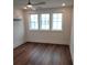 Light filled bedroom with hardwood flooring, mini-split, and three windows at 22 Iron Forge Aly, Charleston, SC 29403