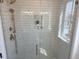 Modern shower featuring white subway tile, glass door and bronze fixtures at 22 Iron Forge Aly, Charleston, SC 29403