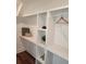 Walk-in closet with custom shelving and wood floor at 22 Iron Forge Aly, Charleston, SC 29403