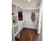 Well-organized walk-in closet with custom shelving and wood floor at 22 Iron Forge Aly, Charleston, SC 29403