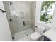 Bathroom featuring glass enclosed shower, toilet, subway tile, and white marble tile floors at 24 Iron Frg Aly, Charleston, SC 29403
