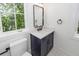 Bathroom with modern lighting, a navy vanity, and white marble countertop at 24 Iron Frg Aly, Charleston, SC 29403