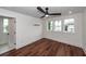 A bright bedroom with hardwood floors, a ceiling fan, recessed lights, and neutral white walls at 24 Iron Frg Aly, Charleston, SC 29403