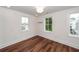 A bright bedroom with hardwood floors, recessed lights, and neutral white walls at 24 Iron Frg Aly, Charleston, SC 29403
