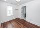 Bedroom with air conditioner, hardwood floors, white walls, and a large window at 24 Iron Frg Aly, Charleston, SC 29403