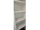 Bright closet with white wood shelving and dark flooring at 24 Iron Frg Aly, Charleston, SC 29403