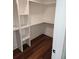 Walk-in closet with custom shelving and hardwood floors at 24 Iron Frg Aly, Charleston, SC 29403