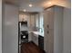 Bright kitchen features white cabinets, stainless appliances, chevron backsplash and a large farmhouse sink at 24 Iron Frg Aly, Charleston, SC 29403