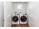 Modern laundry room with a front-load washer and dryer neatly tucked into a closet at 24 Iron Frg Aly, Charleston, SC 29403