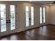 Living room features hardwood flooring and doors to the balcony at 24 Iron Frg Aly, Charleston, SC 29403