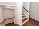 An interior shot of a home's new stairway with wood handrail and wood-look floors at 24 Iron Frg Aly, Charleston, SC 29403